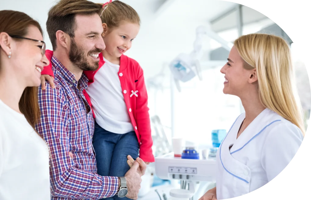 family speaking with dentist
