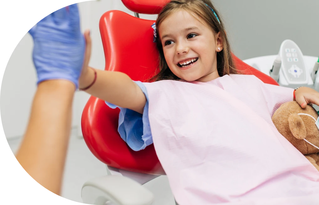 little girl giving dentist highfive