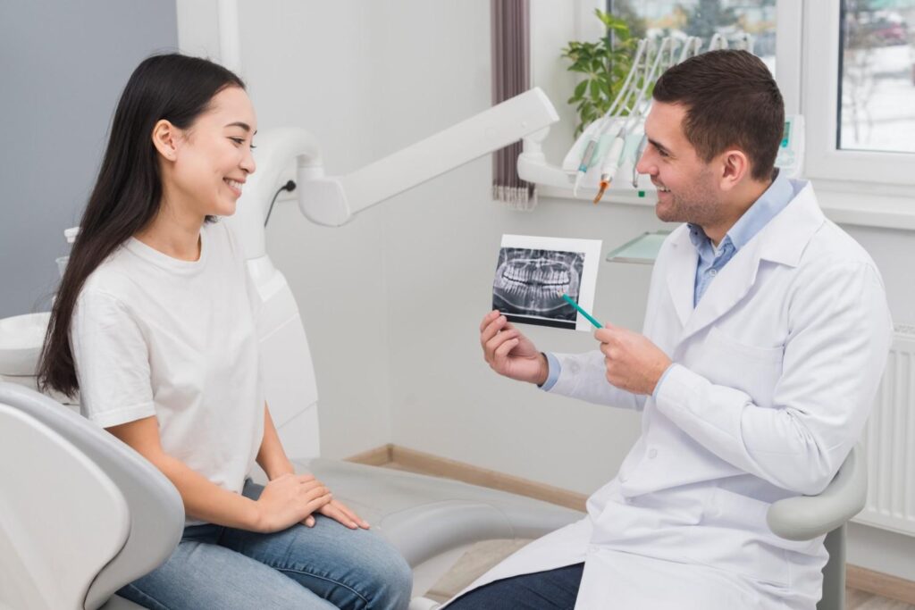 Dentist explaining a dental X-ray to a patient